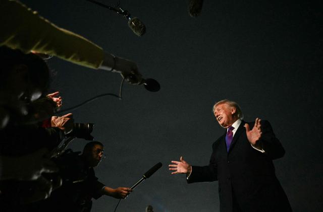 US President Donald Trump speaks to journalists upon returning to Joint Base Andrews, Maryland on March 11, 2026. Trump is returning to the White House following a visit to Kentucky and Ohio. (Photo by Jim WATSON / AFP)