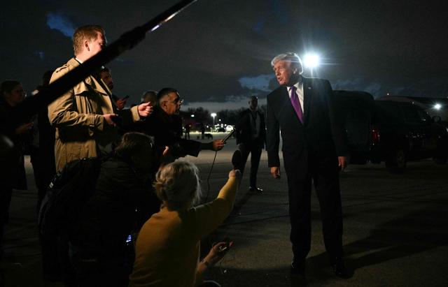 US President Donald Trump speaks to journalists upon returning to Joint Base Andrews, Maryland on March 11, 2026. Trump is returning to the White House following a visit to Kentucky and Ohio. (Photo by Jim WATSON / AFP)