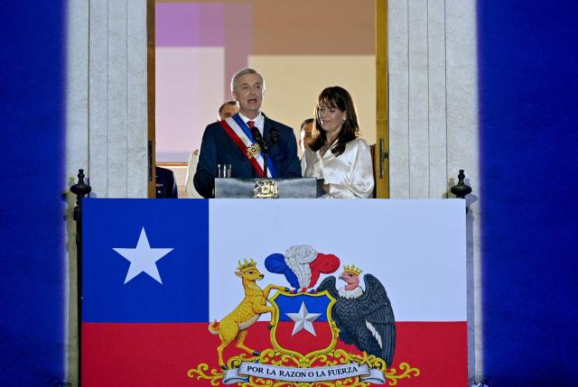 Chile's new President Jose Antonio Kast gives a speech from the balcony of La Moneda Palace next to his wife Maria Pia Adriasola in Santiago on March 11, 2026. Chile's most right-wing president in over three decades, Jose Antonio Kast, takes office on March 11, 2026, on a promise to tackle surging rates of violent crime and carry out mass migrant deportations. (Photo by RODRIGO ARANGUA / AFP)