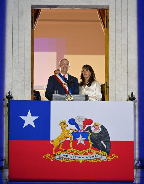 Chile's new President Jose Antonio Kast gives a speech from the balcony of La Moneda Palace next to his wife Maria Pia Adriasola in Santiago on March 11, 2026. Chile's most right-wing president in over three decades, Jose Antonio Kast, takes office on March 11, 2026, on a promise to tackle surging rates of violent crime and carry out mass migrant deportations. (Photo by RODRIGO ARANGUA / AFP)