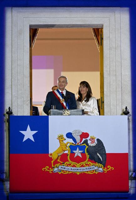 Chile's new President Jose Antonio Kast gives a speech from the balcony of La Moneda Palace next to his wife Maria Pia Adriasola in Santiago on March 11, 2026. Chile's most right-wing president in over three decades, Jose Antonio Kast, takes office on March 11, 2026, on a promise to tackle surging rates of violent crime and carry out mass migrant deportations. (Photo by RODRIGO ARANGUA / AFP)
