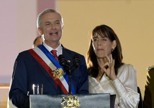 Chile's new President Jose Antonio Kast gives a speech from the balcony of La Moneda Palace next to his wife Maria Pia Adriasola in Santiago on March 11, 2026. Chile's most right-wing president in over three decades, Jose Antonio Kast, takes office on March 11, 2026, on a promise to tackle surging rates of violent crime and carry out mass migrant deportations. (Photo by Rodrigo ARANGUA / AFP)