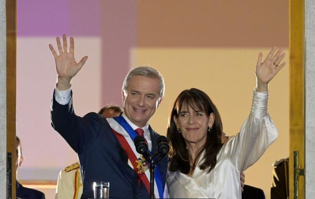 Chile's new President Jose Antonio Kast and his wife Maria Pia Adriasola wave to supporters from the balcony of La Moneda Palace in Santiago on March 11, 2026. Chile's most right-wing president in over three decades, Jose Antonio Kast, takes office on March 11, 2026, on a promise to tackle surging rates of violent crime and carry out mass migrant deportations. (Photo by Rodrigo ARANGUA / AFP)