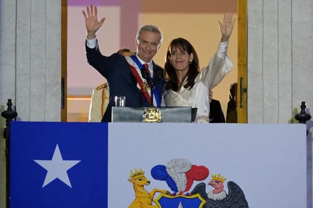 Chile's new President Jose Antonio Kast and his wife Maria Pia Adriasola wave to supporters from the balcony of La Moneda Palace in Santiago on March 11, 2026. Chile's most right-wing president in over three decades, Jose Antonio Kast, takes office on March 11, 2026, on a promise to tackle surging rates of violent crime and carry out mass migrant deportations. (Photo by Rodrigo ARANGUA / AFP)