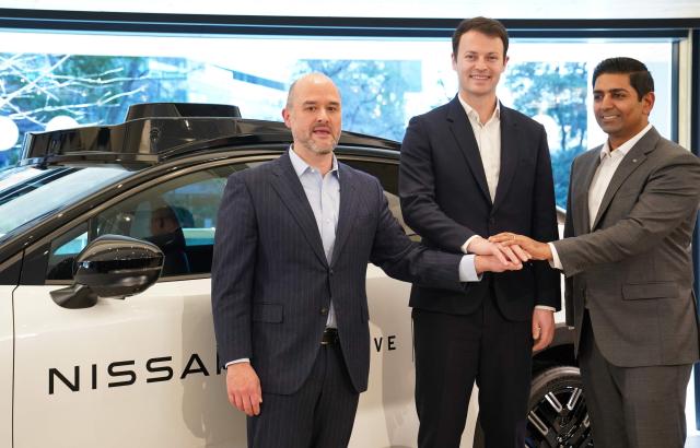 CEO, Nissan Motor Co., Ltd Ivan Espinosa (L), CEO, Wayve Technologies Ltd Alex Kendall (C) and Global Head of Autonomous Mobility and Delivery Uber Technologies Sarfraz Maredia (R) pose with a prototype vehicle during their joint press conference in Tokyo on March 12, 2026. Uber announced on March 12, its first robotaxi partnership in Japan, teaming up with Nissan and British artificial intelligence autonomous driving startup Wayve for a trial this year in Tokyo. (Photo by Kazuhiro NOGI / AFP)