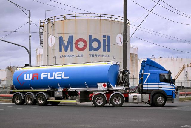 A fuel tanker passes the Mobil fuel distribution centre in the Melbourne suburb of Yarraville on March 12, 2026 as the demands and prices of petrol and diesel soar due to the Middle East conflict. Global oil prices have climbed dramatically since the war, prompting warnings that high fuel prices could drive inflation above 5 per cent in Australia. (Photo by William WEST / AFP)
