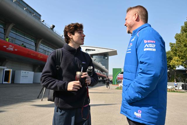 Alpine's Argentine driver Franco Colapinto (L) arrives to the paddock at the Shanghai International Circuit ahead of the Formula One Chinese Grand Prix in Shanghai on March 12, 2026. (Photo by Hector RETAMAL / AFP)