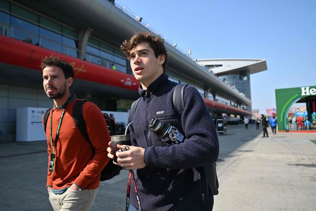 Alpine's Argentine driver Franco Colapinto (R) arrives to the paddock at the Shanghai International Circuit ahead of the Formula One Chinese Grand Prix in Shanghai on March 12, 2026. (Photo by Hector RETAMAL / AFP)