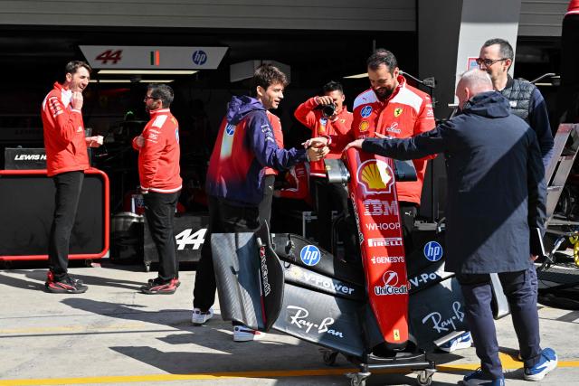 Ferrari's Monegasque driver Charles Leclerc (C) greets Ferrari team members at the Shanghai International Circuit ahead of the Formula One Chinese Grand Prix in Shanghai on March 12, 2026. (Photo by Hector RETAMAL / AFP)