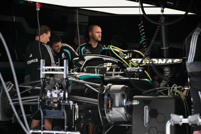 Mercedes’ Italian driver Kimi Antonelli's team members work on the car in the garage at the Shanghai International Circuit ahead of the Formula One Chinese Grand Prix in Shanghai on March 12, 2026. (Photo by Hector RETAMAL / AFP)