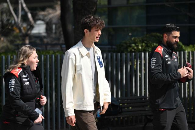 Haas F1 Team's British driver Oliver Bearman (C) arrives to the paddock at the Shanghai International Circuit ahead of the Formula One Chinese Grand Prix in Shanghai on March 12, 2026. (Photo by Hector RETAMAL / AFP)
