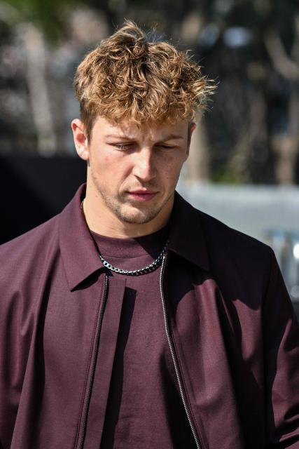 Racing Bulls' New Zealand driver Liam Lawson arrives to the paddock at the Shanghai International Circuit ahead of the Formula One Chinese Grand Prix in Shanghai on March 12, 2026. (Photo by Hector RETAMAL / AFP)