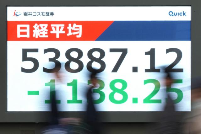 An electronic quotation boards displays the Nikkei Stock Average on the Tokyo Stock Exchange along a street in Tokyo on March 12, 2026. (Photo by Kazuhiro NOGI / AFP)
