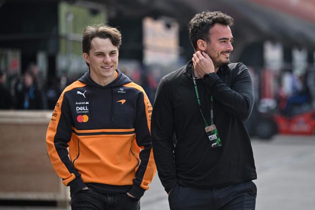 McLaren's Australian driver Oscar Piastri (L) arrives at the paddock ahead of the Formula One Chinese Grand Prix at the Shanghai International Circuit in Shanghai on March 12, 2026. (Photo by Jade GAO / AFP)