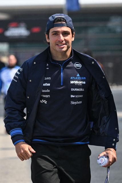 Williams' Spanish driver Carlos Sainz arrives at the paddock ahead of the Formula One Chinese Grand Prix at the Shanghai International Circuit in Shanghai on March 12, 2026. (Photo by Jade GAO / AFP)