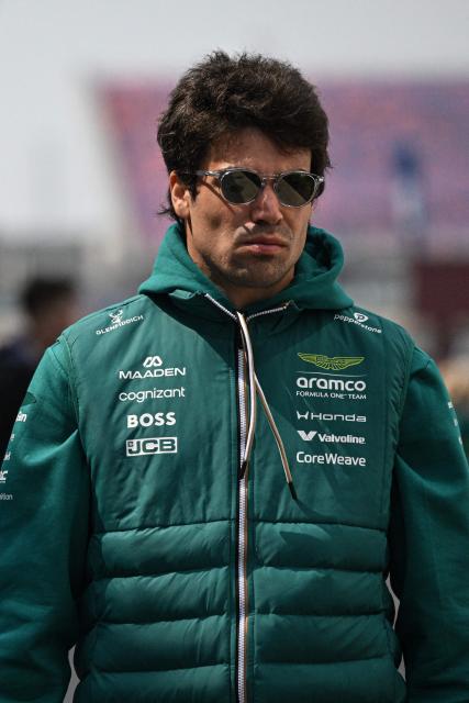 Aston Martin's Canadian driver Lance Stroll arrives at the paddock ahead of the Formula One Chinese Grand Prix at the Shanghai International Circuit in Shanghai on March 12, 2026. (Photo by Jade GAO / AFP)