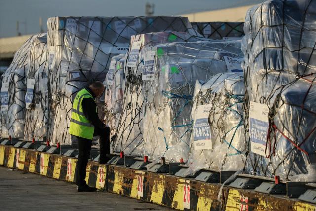 Workers load humanitarian aid into an aircraft destined for Lebanon at Roissy-Charles de Gaulle Airport on the outskirts of Paris on March 12, 2026. France is preparing to triple its humanitarian support to Lebanon by sending 60 tons of aid on March 12, 2026 for refugees leaving the south of the country, where Israel is conducting military operations against the pro-Iranian Hezbollah, the French foreign minister announced on March 11, 2026. (Photo by Dimitar DILKOFF / AFP)