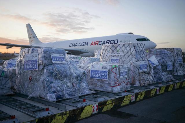 Humanitarian aid is gathered on the tarmac to be loaded into an aircraft destined for Lebanon at Roissy-Charles de Gaulle Airport on the outskirts of Paris on March 12, 2026. France is preparing to triple its humanitarian support to Lebanon by sending 60 tons of aid on March 12, 2026 for refugees leaving the south of the country, where Israel is conducting military operations against the pro-Iranian Hezbollah, the French foreign minister announced on March 11, 2026. (Photo by Dimitar DILKOFF / AFP)