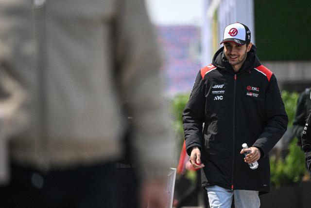 Haas F1 Team's French driver Esteban Ocon arrives at the paddock ahead of the Formula One Chinese Grand Prix at the Shanghai International Circuit in Shanghai on March 12, 2026. (Photo by Jade GAO / AFP)