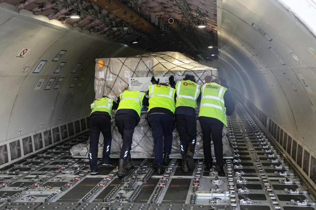 Workers load humanitarian aid into an aircraft destined for Lebanon at Roissy-Charles de Gaulle Airport on the outskirts of Paris on March 12, 2026. France is preparing to triple its humanitarian support to Lebanon by sending 60 tons of aid on March 12, 2026 for refugees leaving the south of the country, where Israel is conducting military operations against the pro-Iranian Hezbollah, the French foreign minister announced on March 11, 2026. (Photo by Dimitar DILKOFF / AFP)