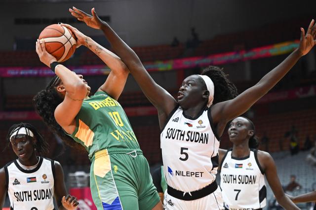 Brazil´s Kamilla Cardoso (L) and South Sudan's Maria Gakdeng compete for the ball during the FIBA Women's Basketball World Cup 2026 qualifying tournament match between Brazil and South Sudan in Wuhan, in China's central Hubei province, on March 12, 2026. (Photo by CN-STR / AFP) / China OUT