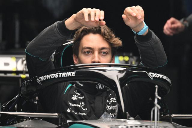 Mercedes' British driver George Russell gets out of his car during preparations ahead of the Formula One Chinese Grand Prix at the Shanghai International Circuit in Shanghai on March 12, 2026. (Photo by GREG BAKER / AFP)