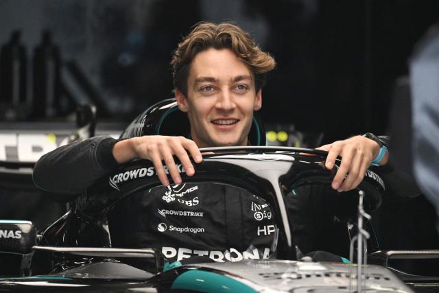 Mercedes' British driver George Russell poses for photos in his car during preparations ahead of the Formula One Chinese Grand Prix at the Shanghai International Circuit in Shanghai on March 12, 2026. (Photo by GREG BAKER / AFP)