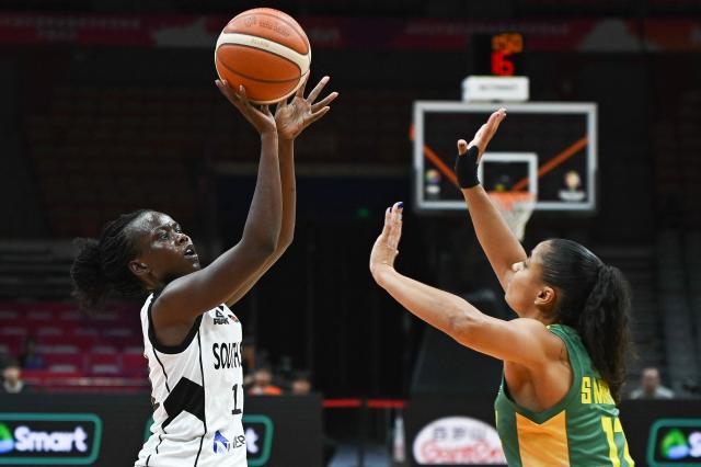 South Sudan's Yar Mayen (L) shoots in front of Brazil's Caca Martins during the FIBA Women's Basketball World Cup 2026 qualifying tournament match between Brazil and South Sudan in Wuhan, in China's central Hubei province, on March 12, 2026. (Photo by CN-STR / AFP) / China OUT