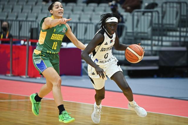 South Sudan's Sarah Deng (R) dribbles past Brazil's Debora Costa during the FIBA Women's Basketball World Cup 2026 qualifying tournament match between Brazil and South Sudan in Wuhan, in China's central Hubei province, on March 12, 2026. (Photo by CN-STR / AFP) / China OUT