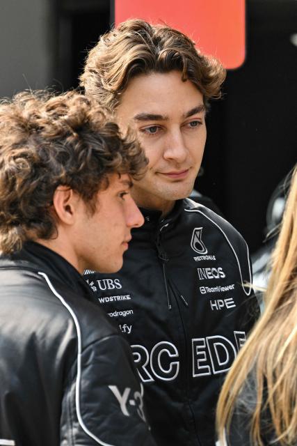 Mercedes' British driver George Russell (R) stands next to Mercedes' Italian driver Kimi Antonelli (L) ahead of the Formula One Chinese Grand Prix at the Shanghai International Circuit in Shanghai on March 12, 2026. (Photo by Hector RETAMAL / AFP)