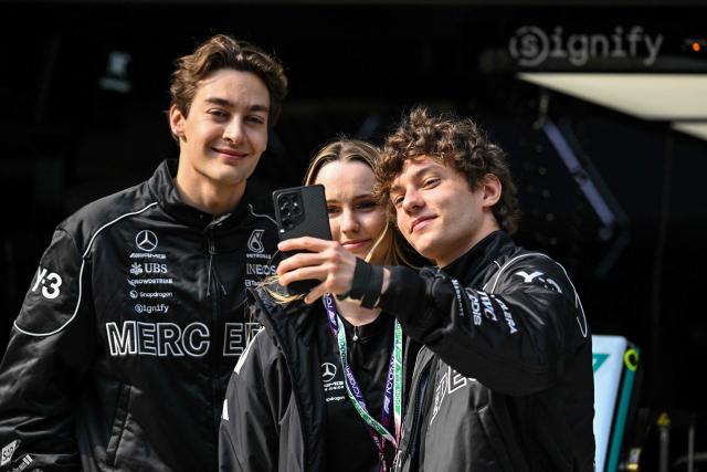 Mercedes' British driver George Russell (L) poses with Mercedes' Italian driver Kimi Antonelli (R) ahead of the Formula One Chinese Grand Prix at the Shanghai International Circuit in Shanghai on March 12, 2026. (Photo by Hector RETAMAL / AFP)