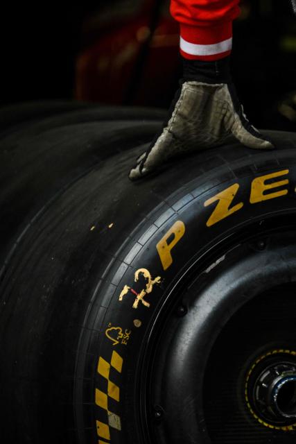A Ferrari team members practices a pit stop with the car of Ferrari's Monegasque driver Charles Leclerc ahead of the Formula One Chinese Grand Prix at the Shanghai International Circuit in Shanghai on March 12, 2026. (Photo by Hector RETAMAL / AFP)