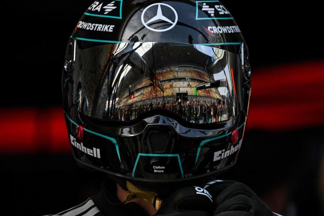 Mercedes team members practice a pit stop with the car of Mercedes' British driver George Russell ahead of the Formula One Chinese Grand Prix at the Shanghai International Circuit in Shanghai on March 12, 2026. (Photo by Hector RETAMAL / AFP)