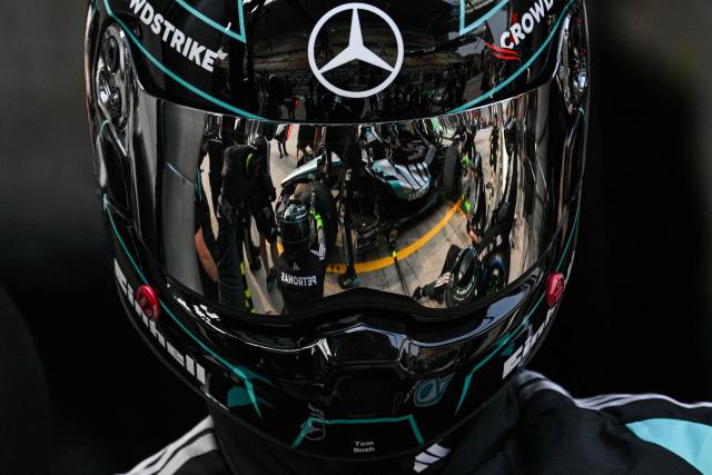 TOPSHOT - Mercedes team members practice a pit stop with the car of Mercedes' British driver George Russell ahead of the Formula One Chinese Grand Prix at the Shanghai International Circuit in Shanghai on March 12, 2026. (Photo by Hector RETAMAL / AFP)