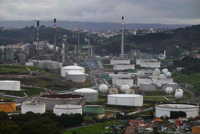 This photograph shows a general view of the Repsol oil refinery in A Coruna, northwestern Spain, on March 11, 2026. The US-Israeli war on Iran has expanded across the Gulf and beyond, upending global energy markets and trade, and virtually halting traffic in the Strait of Hormuz, through which a fifth of the world's crude oil travels. The 32 member countries of the International Energy Agency (IEA) decided to unlock 400 million barrels of oil from their reserves - the biggest such release ever- to ease the impact of the Middle East war. (Photo by MIGUEL RIOPA / AFP)