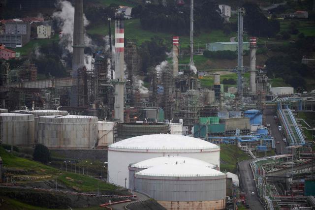 This photograph shows a general view of the Repsol oil refinery in A Coruna, northwestern Spain, on March 11, 2026. The US-Israeli war on Iran has expanded across the Gulf and beyond, upending global energy markets and trade, and virtually halting traffic in the Strait of Hormuz, through which a fifth of the world's crude oil travels. The 32 member countries of the International Energy Agency (IEA) decided to unlock 400 million barrels of oil from their reserves - the biggest such release ever- to ease the impact of the Middle East war. (Photo by MIGUEL RIOPA / AFP)