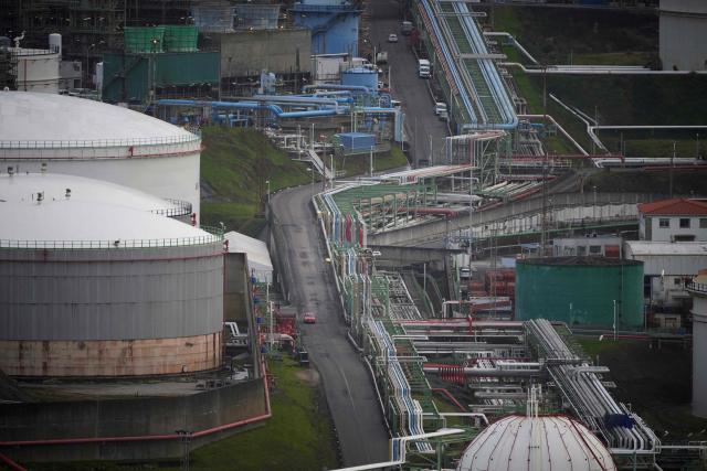 This photograph shows a general view of the Repsol oil refinery in A Coruna, northwestern Spain, on March 11, 2026. The US-Israeli war on Iran has expanded across the Gulf and beyond, upending global energy markets and trade, and virtually halting traffic in the Strait of Hormuz, through which a fifth of the world's crude oil travels. The 32 member countries of the International Energy Agency (IEA) decided to unlock 400 million barrels of oil from their reserves - the biggest such release ever- to ease the impact of the Middle East war. (Photo by MIGUEL RIOPA / AFP)
