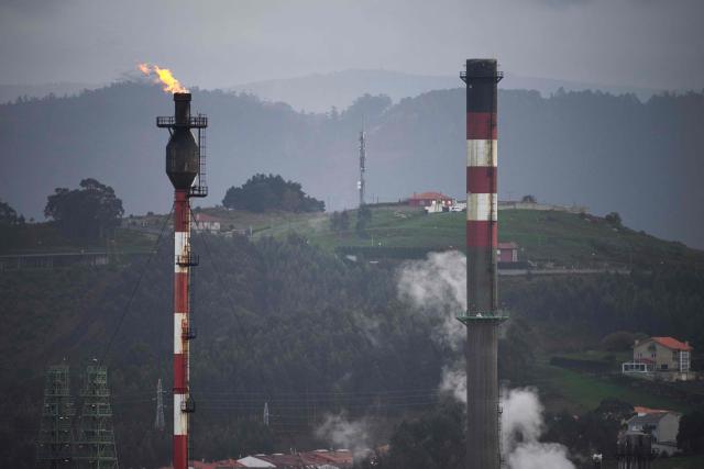 This photograph shows gas flares at the Repsol oil refinery in A Coruna, northwestern Spain, on March 11, 2026. The US-Israeli war on Iran has expanded across the Gulf and beyond, upending global energy markets and trade, and virtually halting traffic in the Strait of Hormuz, through which a fifth of the world's crude oil travels. The 32 member countries of the International Energy Agency (IEA) decided to unlock 400 million barrels of oil from their reserves - the biggest such release ever- to ease the impact of the Middle East war. (Photo by MIGUEL RIOPA / AFP)