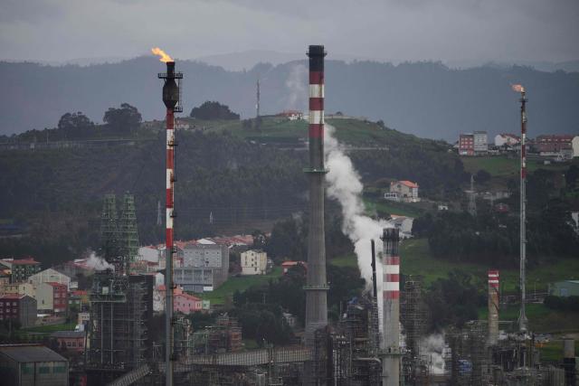 This photograph shows gas flares at the Repsol oil refinery in A Coruna, northwestern Spain, on March 11, 2026. The US-Israeli war on Iran has expanded across the Gulf and beyond, upending global energy markets and trade, and virtually halting traffic in the Strait of Hormuz, through which a fifth of the world's crude oil travels. The 32 member countries of the International Energy Agency (IEA) decided to unlock 400 million barrels of oil from their reserves - the biggest such release ever- to ease the impact of the Middle East war. (Photo by MIGUEL RIOPA / AFP)