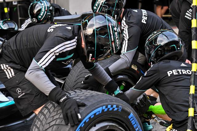 Mercedes team members practice a pit stop with the car of Mercedes' British driver George Russell ahead of the Formula One Chinese Grand Prix at the Shanghai International Circuit in Shanghai on March 12, 2026. (Photo by Hector RETAMAL / AFP)