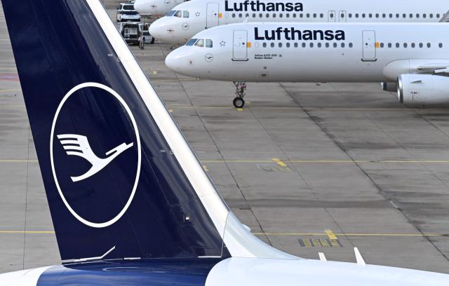 The logo of German airline Lufthansa is seen on several aircraft parked on the tarmac at the international Frankfurt Airport, Frankfurt am Main, western Germany, on March 12, 2026, as pilots for Lufthansa are on strike called by pilots' union Vereinigung Cockpit over a pensions dispute. The strike will affect Lufthansa Cargo and passenger flights "departing from German airports between 00:01 local time on March 12, 2026 and 23:59 local time on March 13, 2026", the union said. However, flights to several key Middle East destinations will be excluded from the industrial action "in light of the current situation" in the region, according to the statement. (Photo by Kirill KUDRYAVTSEV / AFP)