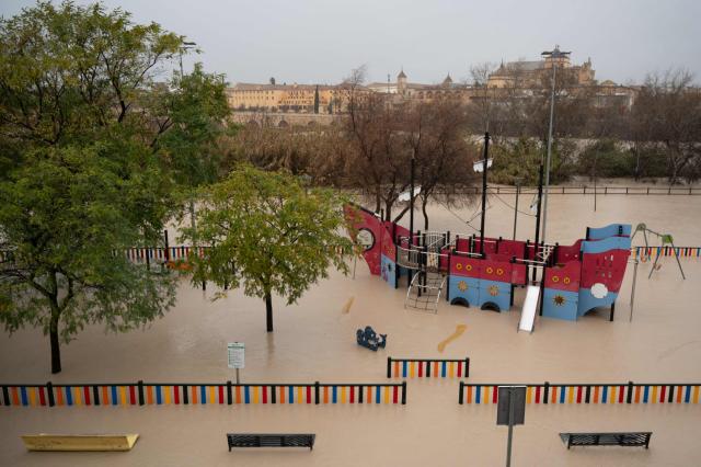 (FILES) A flooded children's playground is seen near the Guadalquivir River in Cordoba on February 7, 2026. Spain saw its highest rainfall levels for January and February in almost fifty years. These storms resulted in several fatalities and the displacement of an entire town, according to a report released on March 12, 2026 by the state meteorological agency, Aemet (Photo by JORGE GUERRERO / AFP)
