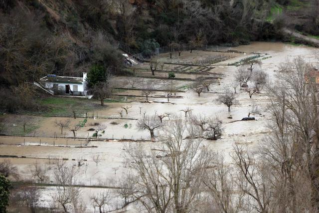 (FILES) Floodwaters from Aguas Blancas river cover fields in Quentar, southern Spain amid Storm Leonardo, on February 5, 2026. Spain saw its highest rainfall levels for January and February in almost fifty years. These storms resulted in several fatalities and the displacement of an entire town, according to a report released on March 12, 2026 by the state meteorological agency, Aemet (Photo by Thomas COEX / AFP)