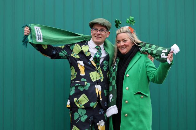 Racegoers mark 'St Patrick's Thursday' with an Irish them, on the third day of the Cheltenham Festival at Cheltenham Racecourse, in Cheltenham, western England on March 12, 2026. (Photo by Adrian Dennis / AFP)