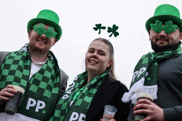 Racegoers mark 'St Patrick's Thursday' with an Irish them, on the third day of the Cheltenham Festival at Cheltenham Racecourse, in Cheltenham, western England on March 12, 2026. (Photo by Adrian Dennis / AFP)