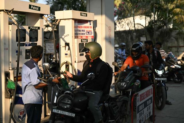 People queue up to refuel their vehicles at a gas station in Chennai on March 12, 2026 as oil price spike caused by the war in the Middle East has sparked exasperation at petrol pumps around Asia, where many economies are heavily dependent on fossil fuel imports. (Photo by R. Satish BABU / AFP)