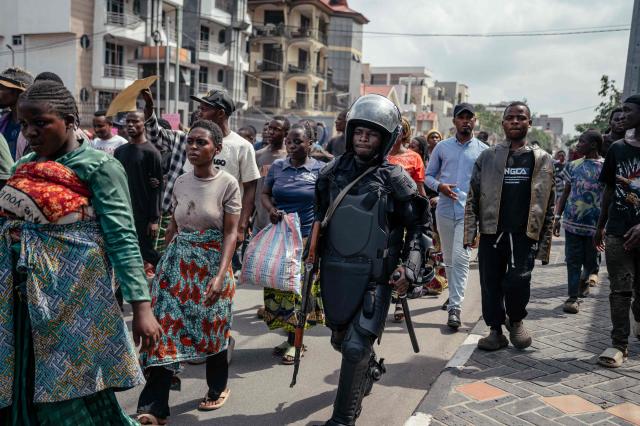 A member of the M23 wearing riot gear patrols in the street to monitor protesters and secure the march denouncing air strikes in areas controlled by the Rwanda-backed M23 militia in Goma on March 12, 2026 a day after a French aid worker for the UN children's agency was killed in an air strike. Humanitarian sources reported that several buildings had been targeted in drone strikes, which UN peacekeeping force MONUSCO said also killed two civilians.
The strikes' origin remained unclear. (Photo by Jospin Mwisha / AFP)