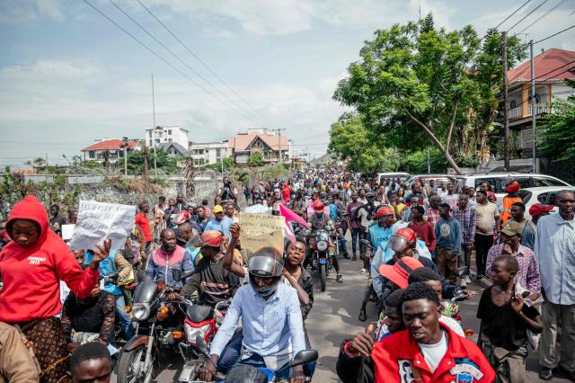 Protesters march during a protest denouncing air strikes in areas controlled by the Rwanda-backed M23 militia in Goma on March 12, 2026 a day after a French aid worker for the UN children's agency was killed in an air strike. Humanitarian sources reported that several buildings had been targeted in drone strikes, which UN peacekeeping force MONUSCO said also killed two civilians.
The strikes' origin remained unclear. (Photo by Jospin Mwisha / AFP)