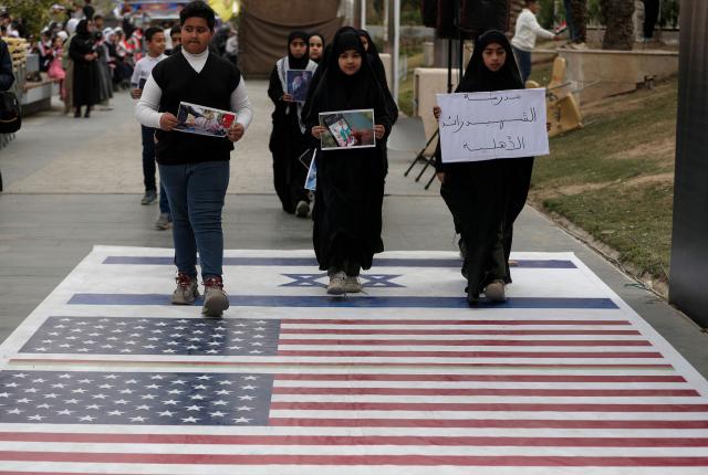 Schoolchildren participate in an anti-US and Israeli demonstration in Baghdad on March 12, 2026.. Air strikes killed at least nine Iran-backed fighters in Iraq on March 12 near the Iraqi-Syrian border, two senior security officials told AFP. The Middle East war, which was triggered on February 28 by American-Israeli attacks on Iran, is hampering the global economy's supply of oil and weakening production capacity. (Photo by AHMAD AL-RUBAYE / AFP)