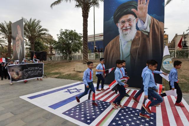 Schoolchildren participate in an anti-US and Israeli demonstration in Baghdad on March 12, 2026.. Air strikes killed at least nine Iran-backed fighters in Iraq on March 12 near the Iraqi-Syrian border, two senior security officials told AFP. The Middle East war, which was triggered on February 28 by American-Israeli attacks on Iran, is hampering the global economy's supply of oil and weakening production capacity. (Photo by AHMAD AL-RUBAYE / AFP)